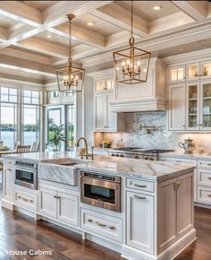 a large kitchen with white cabinets and marble counter tops