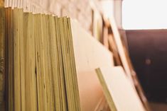 a stack of books sitting on top of a wooden shelf