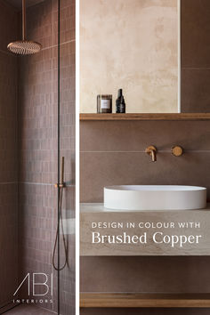 a bathroom with brown tiles and a white sink in the shower area next to a tan tiled wall