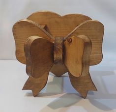 a wooden toy with a bow on it