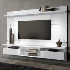 a white entertainment center with a flat screen tv mounted on it's side wall