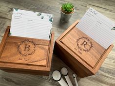 two personalized wooden boxes with notepads and spoons next to each other