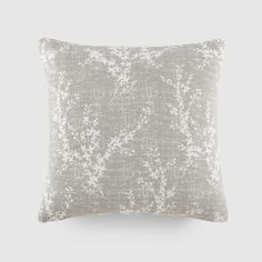 a grey and white pillow on a gray background