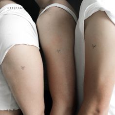 two women with small tattoos on their arms and legs, both wearing white underwears