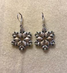 Handmade beaded earrings of silver accents on gold diamond duos beads. Silver tone lever back finish. Handmade Beaded Earrings, Duo Beads, Snowflake Earrings, Handmade Earrings Beaded, Bead Embroidery, May 27, Silver Accents, Beaded Earrings, Gold Diamond