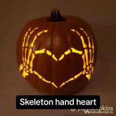 a carved pumpkin with the words skeleton hand heart on it