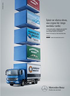 a blue truck is parked in front of a stack of boxes with advertisements on them