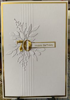 a white and gold birthday card on a table