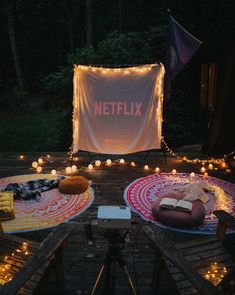 a couple of plates that are sitting on a wooden table with lights around them and a netflix sign in the background