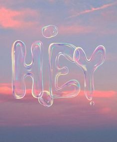 the word hey written in soap bubbles against a pink and blue sky with clouds behind it