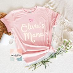 Personalized Mama Shirt With Kids Names, Custom Mama Shirt, Mom Heart Shirt With Baby Names, New Mom New Mama Baby Shower Christmas Gifts ❤ Bella And Canvas Brand Shirts & Unisex Adult Sizing This classic unisex jersey short-sleeve tee fits like an old favorite, offering a perfect blend of comfort and style. Made from soft cotton and featuring a high-quality print, it quickly becomes a go-to item you'll love. Crafted with a lightweight fabric (4.2 oz/yd² or 142 g/m it is both breathable and idea Personalized Pink Tops For Mother's Day, Cute Mother's Day Shirt With Name Print, Cute Name Print Shirt For Mother's Day, Personalized Pink Short Sleeve Tops, Family Matching Pink Tops For Valentine's Day, Pink Top For Mother's Day Gift, Pink Tops For Mother's Day Gift, Personalized Short Sleeve Tops For Valentine's Day, Personalized Pink Top As Gift