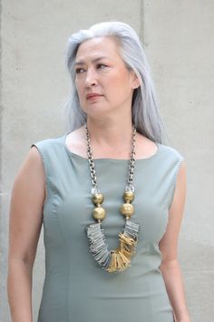 The Mya Lambrecht Trio Necklace will give you the air of confidence! Material: Metal, brassOrigin: Made in Minnesota Designer pieces Crystal beads Assorted mixed metal chain Antique brass trade beads from Nepal Handmade 31" long Mya Lambrecht incorporates everyday objects into her pieces that are seemingly out of place Long Gold Brass Beaded Necklace, Long Gold Beaded Brass Necklace, Bronze Brass Necklace With Beaded Chain, Artisan Multi-strand Gold Necklace, Artisan Gold Necklace With Beaded Chain, Gold Necklace With Oxidized Finish, Artisan Gold Beaded Brass Necklace, Brass Beaded Necklaces For Jewelry Making, Fusion Style Gold Necklace With Oxidized Finish