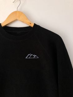 Unisex Embroidered Crewneck Sweatshirt // Let's adventure to the coast, the evergreens and beyond. -Crewneck shown is Black with White thread, in Navy Blue with White thread in a size L and in Ocean Blue with White thread in a size L -Embroidered design -50% cotton, 50% polyester -Double-needle stitched collar, shoulders, arm cuffs, and hem -1x1 athletic rib-knit collar with spandex -Air-jet spun yarn for a soft feel and reduced pilling -Pre-shrunk The perfect crewneck for an adventure, whether Black Crew Neck Sweatshirt For Outdoor, Relaxed Fit Crew Neck Tops For Hiking, Sporty Crew Neck Tops For Adventure, Minimal Sweatshirt Design, Winter Outdoor Crew Neck Tops, Winter Crew Neck Top For Outdoor, Cotton Tops With Ribbed Cuffs For Outdoor Activities, Outdoor Crew Neck Cotton Sweater, Crew Neck Cotton Top For Hiking