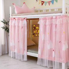 there is a bunk bed with pink curtains on it