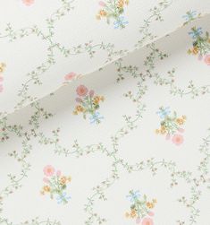 an image of a flowered fabric with flowers and leaves on white background, close up