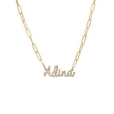 The Adina Eden Diamond Script Name Link Necklace in 14K Gold exudes elegance and sophistication. Crafted with meticulous attention to detail, this necklace features round brilliant-cut natural diamonds adorning the delicate script letters, adding a touch of luxury. The lowercase script font, with the first letter capitalized, creates a personalized and refined look. Based on the 'Adina' necklace, it can be customized with 2-9 letters, making it a perfect choice for showcasing your unique identity. The necklace is complemented by a paperclip chain, with each link approximately 5mm in size, and it comes with a length of 16 inches plus a 1-inch extender, ensuring a comfortable and adjustable fit. Elevate your style with this exquisite piece of jewelry that seamlessly combines timeless design Script Letters, Gold Link Chain, Script Lettering, Script Font, Link Necklace, Paper Clip, Pave Diamonds, Round Brilliant, Natural Diamonds