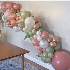 the balloon garland is hanging on the wall