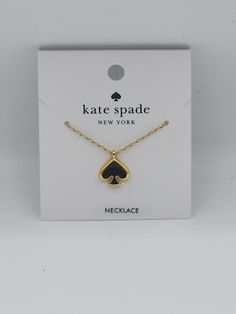 This Kate Spade necklace features a black enamel spade pendant with a gold-tone finish. The pendant is attached to a cable chain with an adjustable lobster closure, making it suitable for all occasions. The necklace is handmade and has a unique charm pendant shape. The pendant has a spade shape and is eye-clean, with no stone treatments. The necklace has a main stone shape of spade and is not antique or vintage. It is a beauty theme and was manufactured in China. The necklace comes with a package that includes the necklace length, but this is not specified in the product. Kate Spade Clothes, Spade Necklace, Kate Spade Necklace, Gold Charm Necklace, Kate Spade Jewelry, Gold Tone Necklace, Fashion Jewelry Necklaces, Unique Charms, Black Enamel