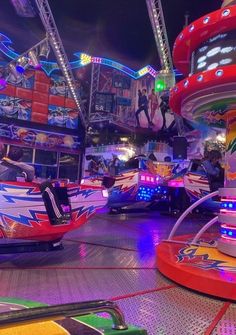 an amusement park filled with colorful rides at night