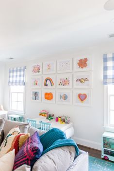 a living room filled with furniture and pictures on the wall