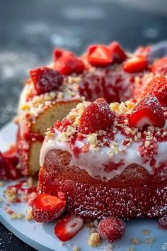 a piece of cake with strawberries on top is sitting on a plate and has been sliced