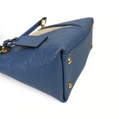 Louis Vuitton 'V Tote BB' handbag in blue monogram empriente leather with cream leather panels and gold hardware. Features double rolled handles and a removable shoulder strap. The bag has a two-way zip closure and blue suede lining wth two slip pockets. Includes dust bag. Brand = Louis Vuitton Condition = 8/10, Very good. light wear to corners, small mark on front of bag, fading to hardware. Dimensions = 10.5" x 4.25" x 7" Strap Drop = 21"-23" Material = Leather SKU = 13406-111 Blue Suede, Blue Cream, Sneaker Collection, Blue Bags, Dress With Boots, New Bag, Loafer Shoes, Mini Bag, Bags Women