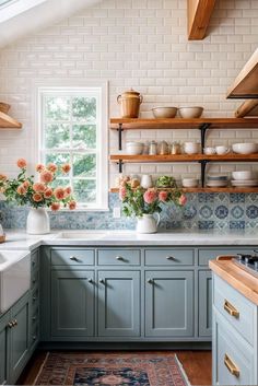 a kitchen filled with lots of counter top space next to a stove top oven and sink