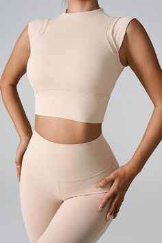 Mock Neck Active Tank - SHANKARA CHÉRIE Sleeveless Sportswear Tops, Sleeveless Elastane Sportswear Top, Stretch Cotton Crop Top For Sports, Stretch Cotton Sports Crop Top, Sleeveless Elastane Top For Pilates, Beige Compression Seamless Activewear, Beige Seamless Compression Activewear, Cotton Fitted Activewear For Pilates, Fitted Cotton Activewear For Pilates