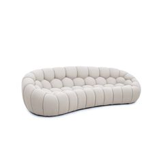 a white couch sitting on top of a white floor