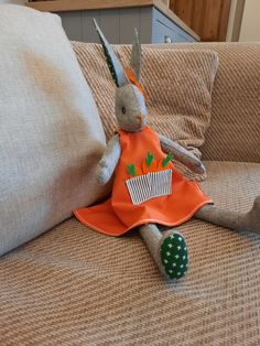 a stuffed rabbit sitting on top of a couch