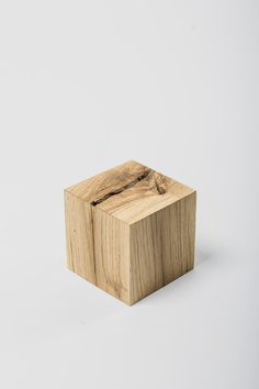 a wooden object sitting on top of a white surface