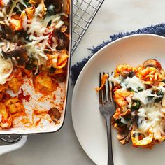 a white plate topped with lasagna next to a casserole dish