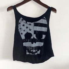 New Never Worn. Brandy Melville Skull Crop Top One Size Fits All Edgy Black Top With Skull Print, Black Grunge Skull Print Tops, Black Skull Print Tops For Alternative Fashion, Black Emo Top With Skull Print, Black Cotton Tank Top With Skull Print, Alternative Style Skull Print Summer Tops, Alternative Style Skull Print Tops For Summer, Casual Tops With Skull Shape For Alternative Fashion, Casual Skull Print Tank Top For Streetwear