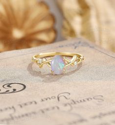 Twisted Opal Engagement Ring, Oval Cut Opal Ring Yellow Gold, Vine Opal Ring, Vintage Twig Ring Ring#:NC1048 Center stone: Opal oval cut 5*7mm Side stones: moissanite Shape: Round cut Size/weight:1.3mm Custom orders are most welcome! Please feel free to ask for any item, any adjustments or anything else you want me to make. Rush order Orders can be expedited for a fee. If your order needs to be expedited, please contact us ASAP. Layaway plan We offer layaway plan that works with a $100 as the fi Simple Opal Engagement Ring, Oval Opal Promise Ring, Oval Opal Ring For Anniversary, Gold Oval Crystal Promise Ring, Heirloom Oval Opal Ring For Anniversary, White Gold Oval Rings For Marriage, Oval White Gold Ring For Marriage, Oval White Gold Marriage Ring, Oval Solitaire Opal Ring Fine Jewelry