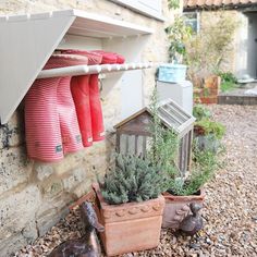 an instagram page with red rain boots hanging from the side of a brick building