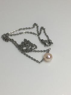 "5mm Peach cream solitaire fresh water pearl hypoallergenic stainless steel sturdy shiny cable chain lobster claw closure necklace. Available in 14\",15\",16\", 18\" Hand made jewelry! All purchase will arrive in gifts boxes Thanks for stopping by! See similar listings https://www.etsy.com/listing/746071892/single-pearl-necklace-solitaire-pearl?ref=shop_home_active_1&frs=1 https://www.etsy.com/listing/746055542/single-pearl-necklace-solitaire-pearl?ref=shop_home_active_3&frs=1" Stainless Steel Pearl Chain Necklace For Gift, Pearl Cable Chain Necklaces As Gift, Gift Jewelry With Pearl Chain In Stainless Steel, Gift Jewelry With Pearl Chain And Stainless Steel, Stainless Steel Jewelry With Pearl Chain For Gifts, Pearl Necklace With Cable Chain For Gift, One Pearl Necklace, Gifts Boxes, Single Pearl Necklace