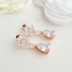 Petite and sparkly, the Nicole rose gold drop earrings are part of the Nicole collection. I have created them with faceted cubic zirconia ear tops onto which I have put cubic zirconia teardrop crystals for lots of shine. Material used is rose gold plated brass. I also have them in silver/rhodium finish and 14k gold finish. All material used is nickle free. They are small but pack a good punch and light weight on the ears. Great for all day wear. # length of Earring from top approx. -1 1/8 inches Rose Gold Cubic Zirconia Bridal Earrings For Wedding, Rose Gold Cubic Zirconia Earrings For Wedding, Rose Gold Teardrop Bridal Earrings For Anniversary, Rose Gold Teardrop Bridal Earrings For Wedding, Rose Gold Cubic Zirconia Wedding Earrings, Rose Gold Dangle Crystal Earrings For Wedding, Rose Gold Dangle Earrings For Wedding, Rose Gold Cubic Zirconia Earrings For Bridesmaids, Rose Gold Cluster Earrings For Wedding