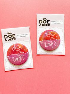 two stickers that are on top of a pink surface with the words doe a deer