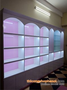 an empty room with pink shelves and checkered floor