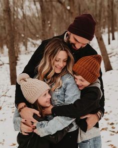 a man and two women hugging each other in the snow