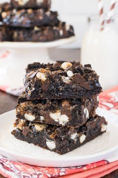 three different views of cookies and chocolate on a white plate with milk in the background