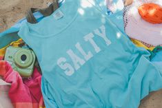 Salty Unisex tank top. Each t-shirt is pressed house on a Comfort Colors unisex tank top. Tanks are made of a soft cotton blend and features a vibrant direct to fabric transfer design that won't fade or crack. COLOR PICTURED: Chalky Mint Shop our coordinating bandana here: Shop our summer inspired apparel collection. Perfect for those who enjoy swimming, camping, exploring the outdoors and all adventure seeking enthusiasts. keywords: lake tank top, summer apparel, racer back tanks, graphic tees, boat shirts, lake aesthetic, trendy summer apparel, women's summer apparel, beach apparel, beach tank tops, comfort color tanks Care Instructions:• DO NOT dry clean• Machine wash COLD with mild detergent• Turn inside out when washing• Dry on low setting or hang to dry• Wait 24 hours before first wa Summer Cotton Tank Top With Letter Print, Sleeveless Cotton T-shirt For Summer, Summer Cotton Racerback Tank Top, Summer Cotton Workout Tops, Summer Workout Cotton Tops, Cotton Racerback Muscle Tee For Summer, Summer Cotton Tank Top For Workout, Summer Cotton Workout Tank Top, Cotton Tank Top With Screen Print For Spring