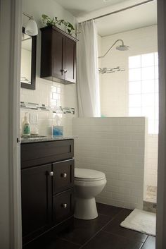 a white toilet sitting next to a bathroom sink