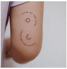 a person with a tattoo on their arm that says live by the sun, love by the moon