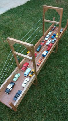 a toy car track with cars on it in the grass