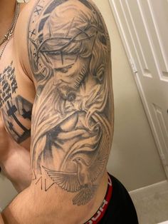 a man with tattoos on his arm and shoulder