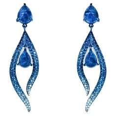 Earrings crafted in Titanium with 198 handset stones: Tanzanite cabochons 6.03 carats, Sapphires 2.48 carats and White Diamonds 0.08 carats. 5.8cm x 1.5cm total size. Intricate work in titanium is done by hand by highly skilled craftsmen in Italy. Inspired by the striking steel curves of artist Richard Serra’s work and the iconic undulating lines of master architects Zaha Hadid and Santiago Calatrava, these earrings extracts the softness within these bold, unconventional forms to create delicate Sapphire Earrings With Pave Setting In Fine Jewelry Style, Sapphire Earrings With Pave Setting, Silver Sapphire Earrings With Pave Setting, White Gold Sapphire Earrings With Pave Setting, Blue Pave Set Earrings For Formal Occasions, Formal Blue Pave Set Earrings, Formal Teardrop Sapphire Earrings, Formal Sapphire Earrings For Pierced Ears, Formal Sapphire Earrings