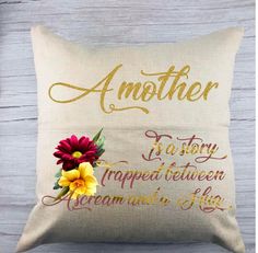 an embroidered pillow with flowers on it and the words, another to story is written in gold