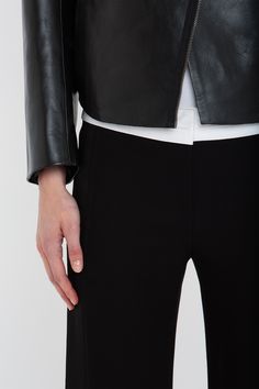 Firm calf leather imbues the Tailored Biker Jacket with a structured, boxy silhouette that will bring a utilitarian counterpoint to feminine separates. Design features include a bonded front panel detail, waist pockets and a double-ended zip. Designed in enduring Black, it is a modern classic. Styled with the Victoria T-Shirt, Alina Tailored Trouser & the Chain Pouch Bag Victoria Beckham Tailored Leather Biker Jacket In Black  - Size 10 UK Size 12 Uk, Leather Biker Jacket, Tailored Trousers, Pouch Bag, Biker Jacket, Victoria Beckham, Modern Classic, The Chain, Calf Leather