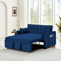 a living room with a blue couch and white rug